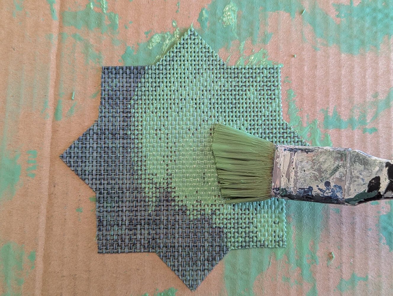 painting the placemat with a paint wash.
