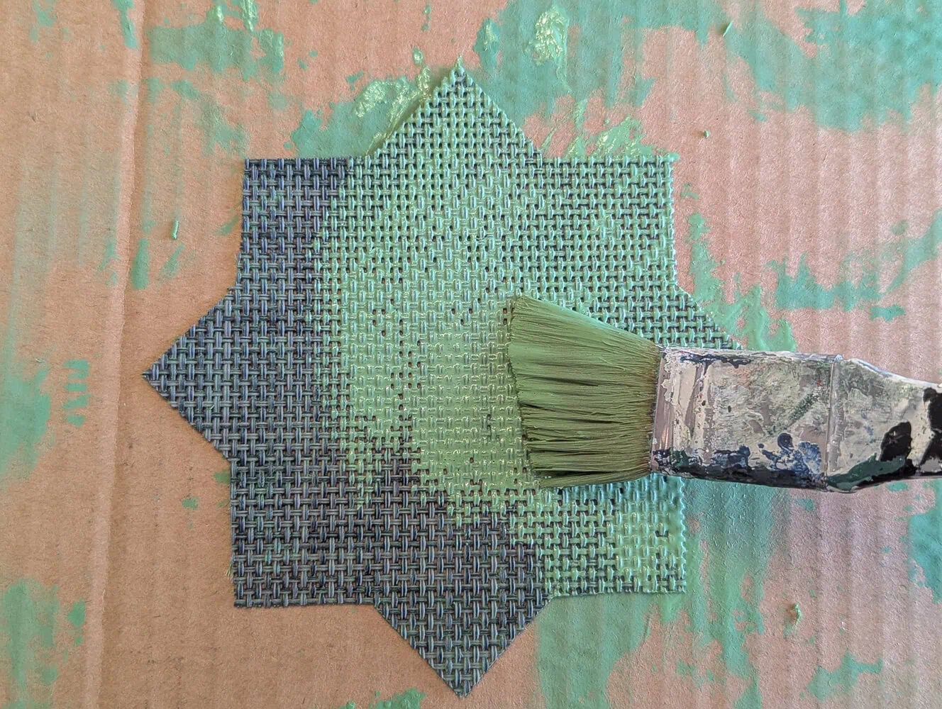 painting the placemat with a paint wash.