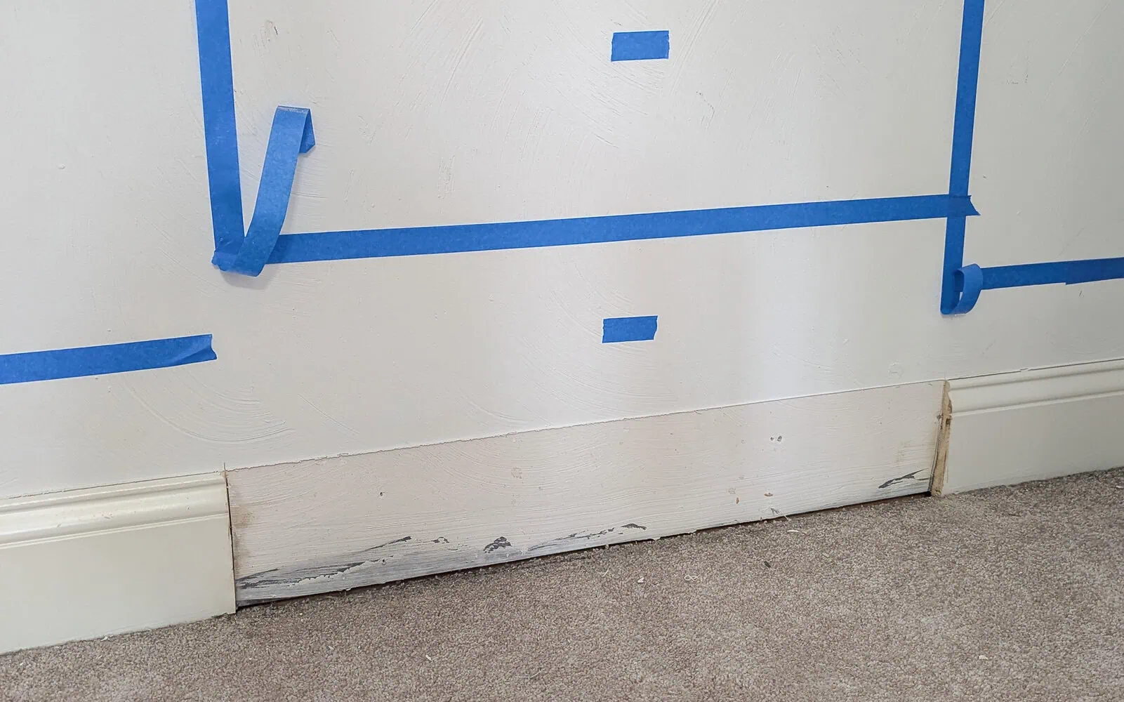 closet with baseboards cut out.