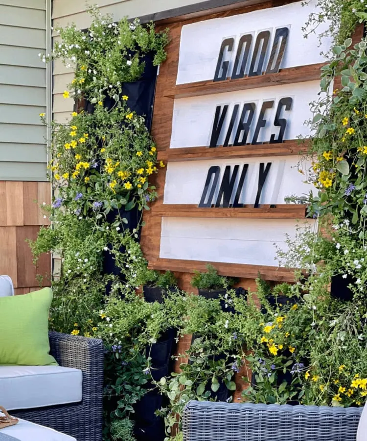 outdoor living wall with good vibes only sign