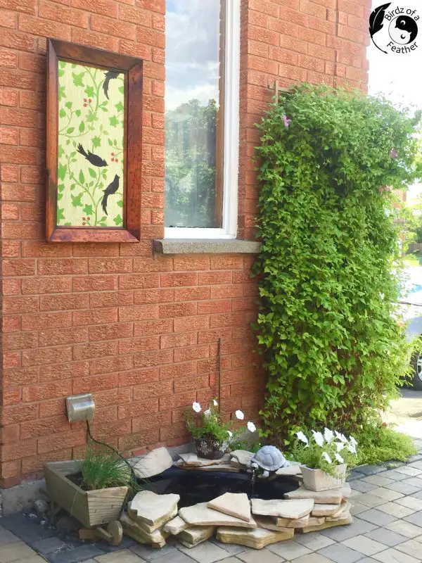 painted wood wall art on patio