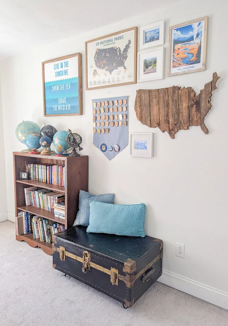 bookcase, gallery wall, and bench made from a vintage trunk in boy's bedroom.