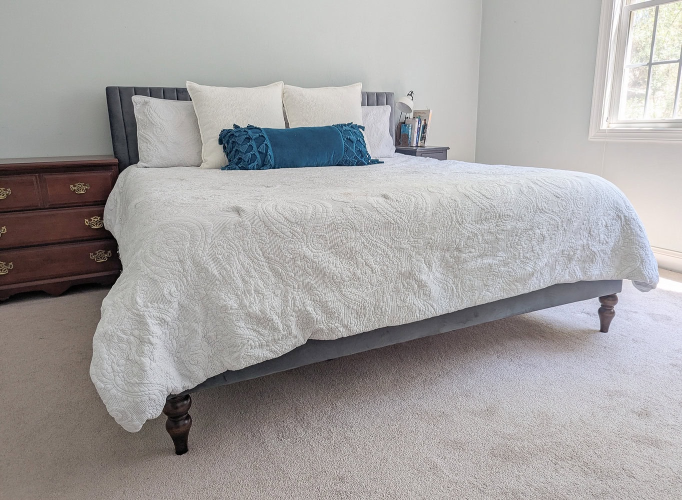 upholstered bed with new wooden bed legs.