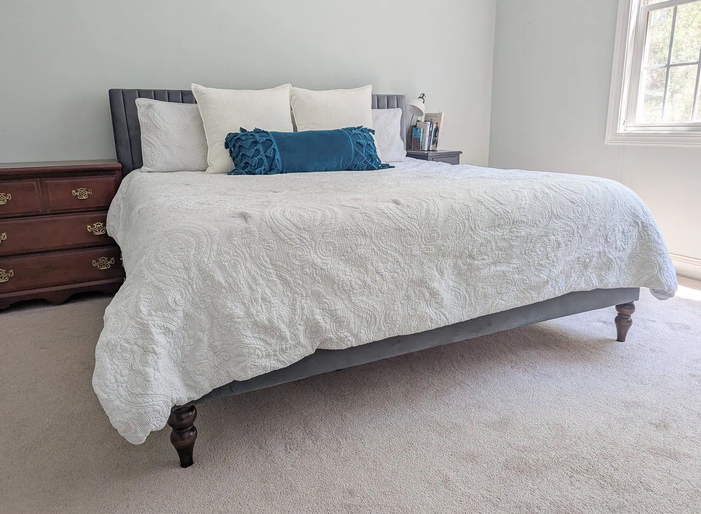 upholstered bed with new wooden bed legs.