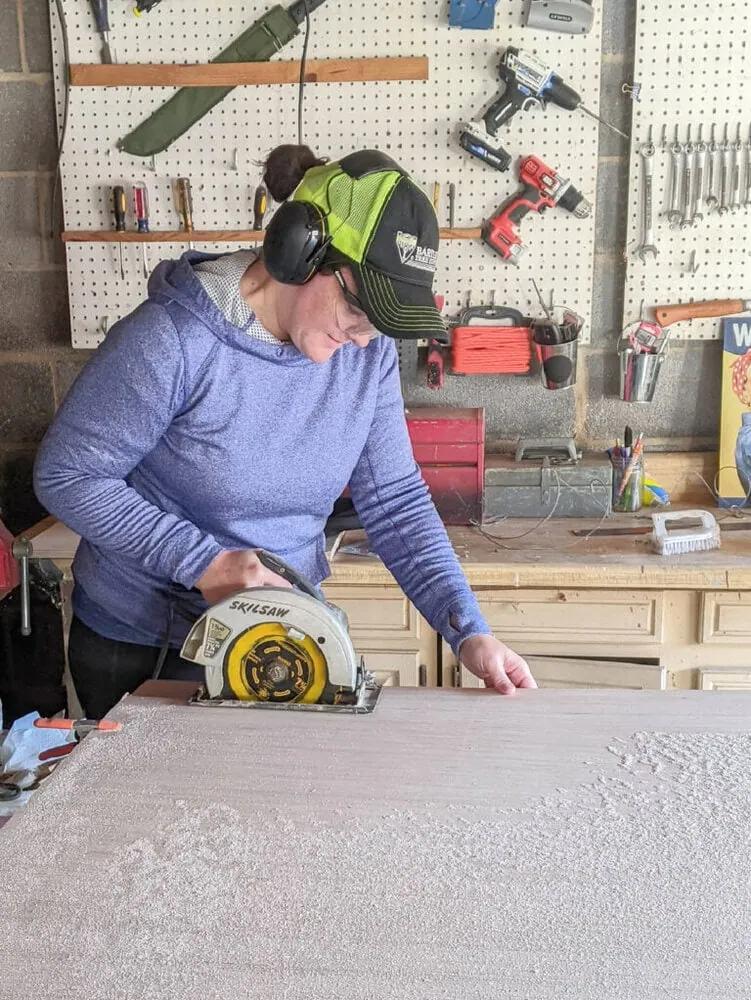lady cutting plywood with a circular saw.