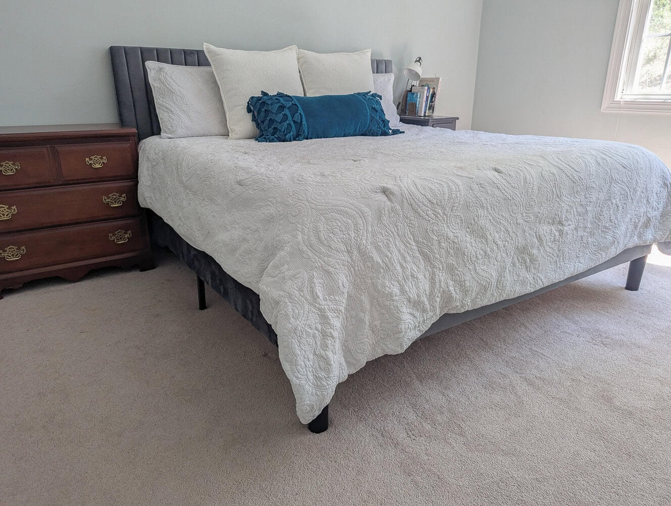 gray velvet upholstered bed.