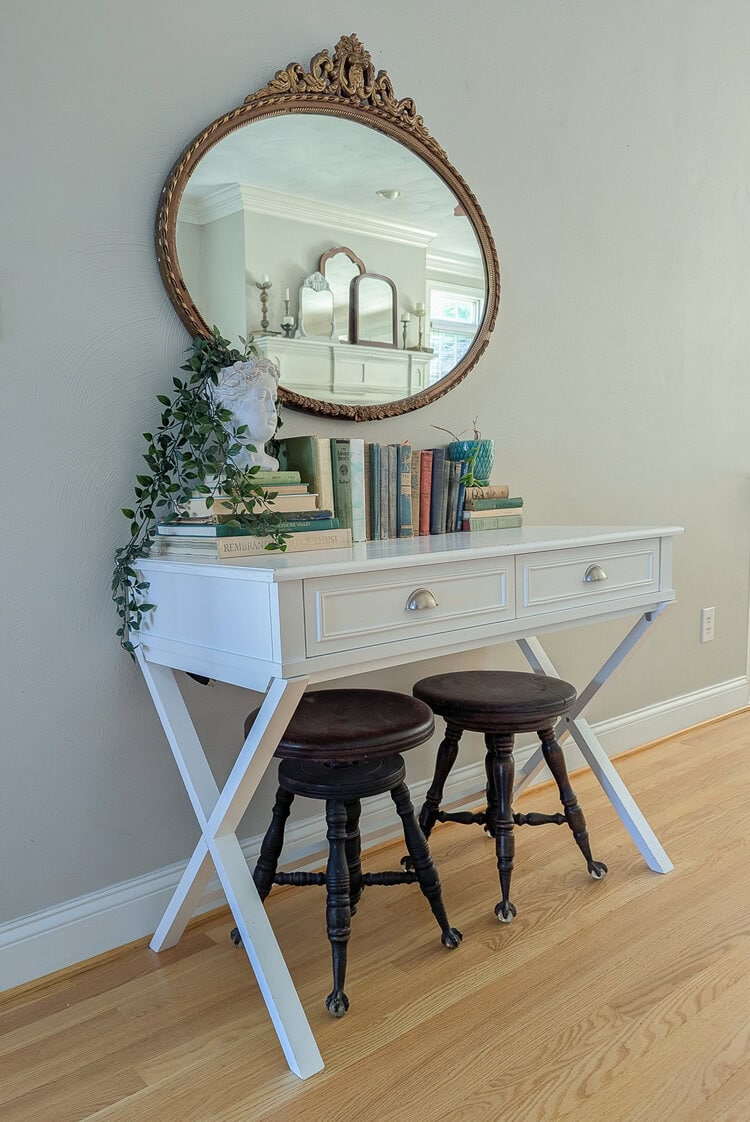 white writing desk with gold antique mirror and brushed nickel hardware.