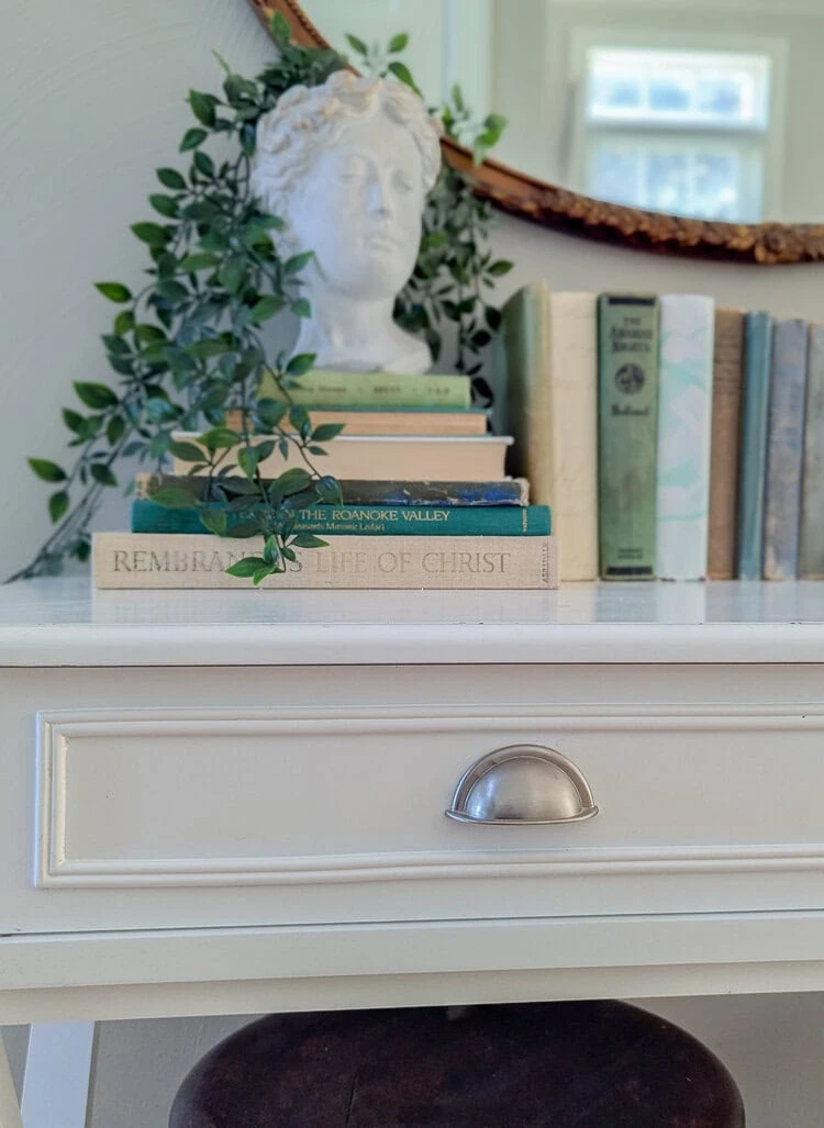 close up of brushed nickel bin pulls on white desk.