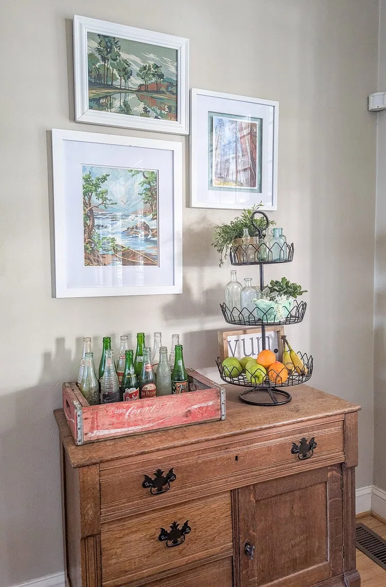 simple gallery wall of white framed paintings.