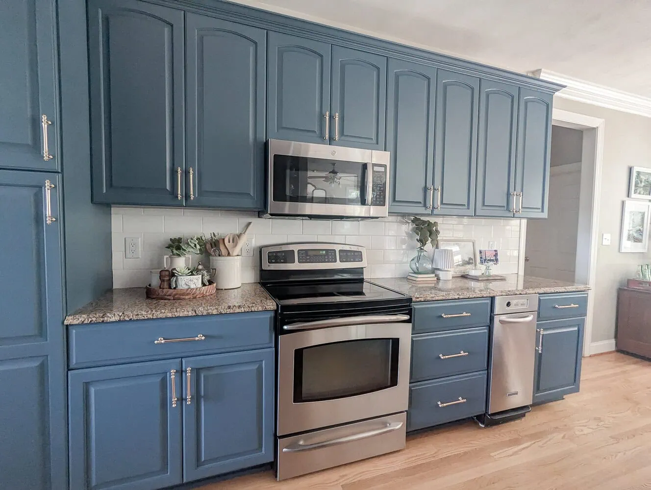 kitchen with deep blue painted cabinets and brass hardware.