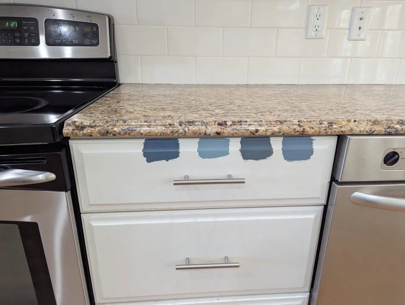 white cabinets with four different blue paint samples.