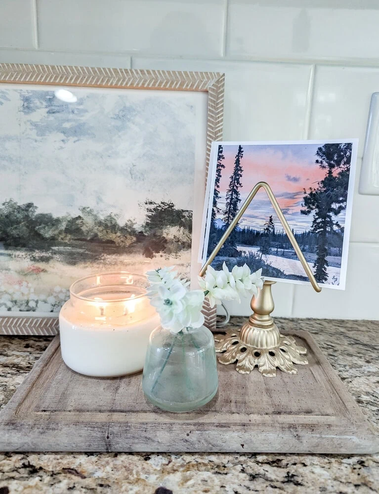 napkin holder used to display photos on countertop.