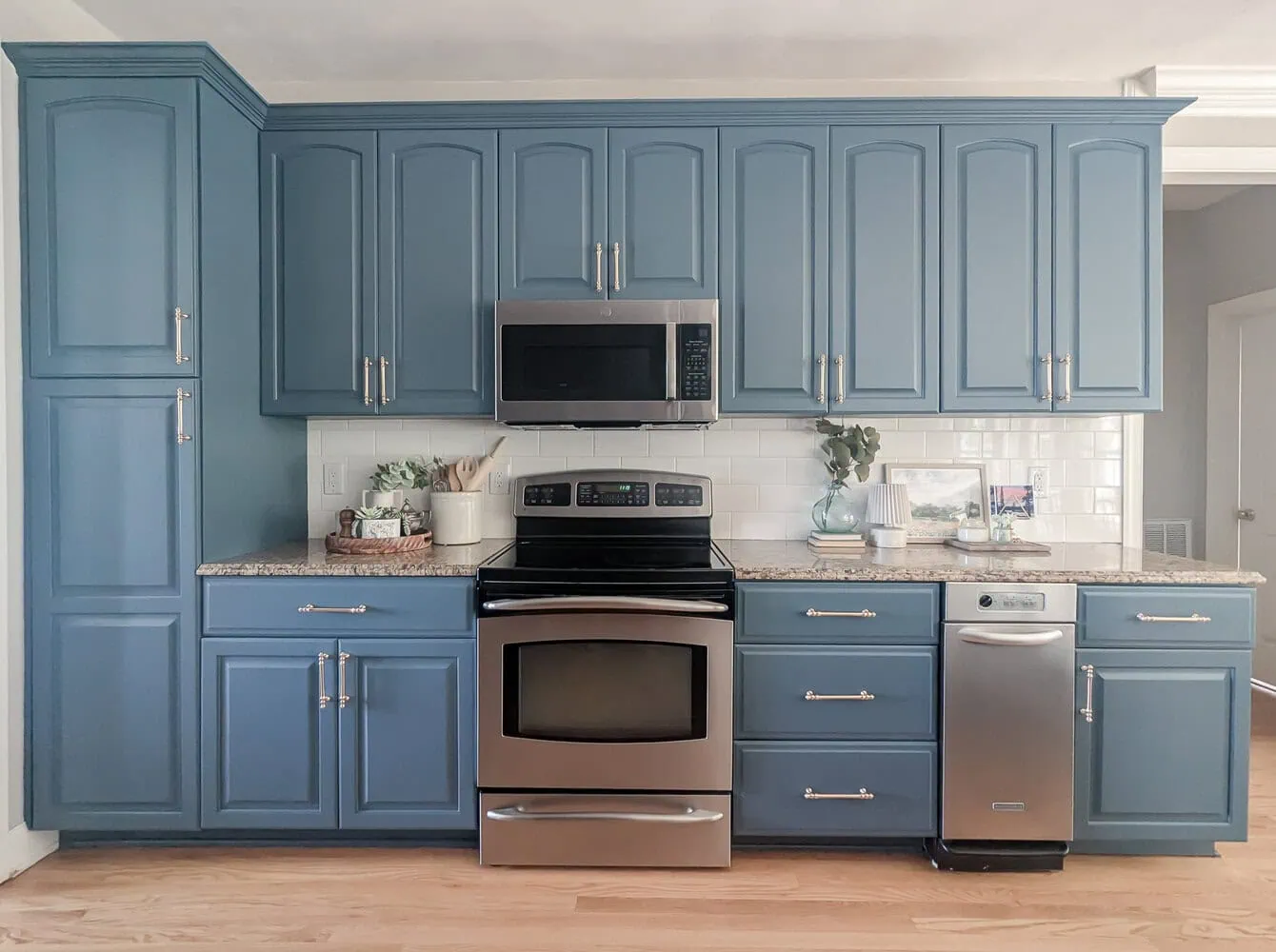 kitchen with dark blue cabinets and brown granite countertops.