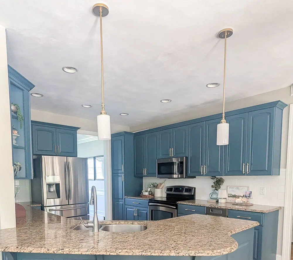 Kitchen with pendant lights spray painted gold.