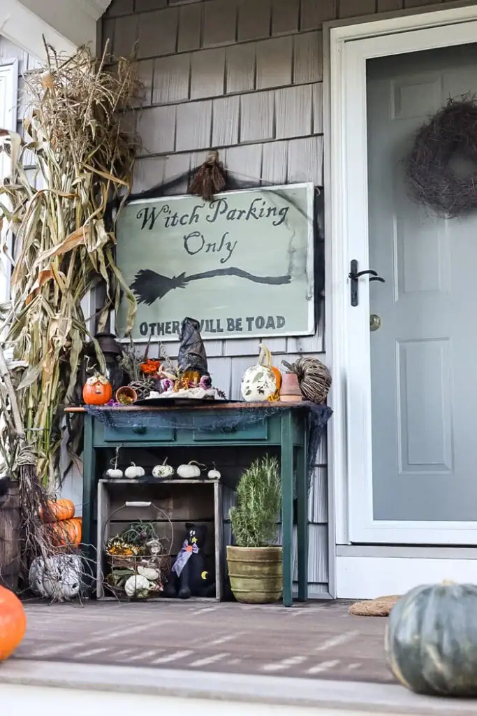 front porch with diy witch sign and pumpkins