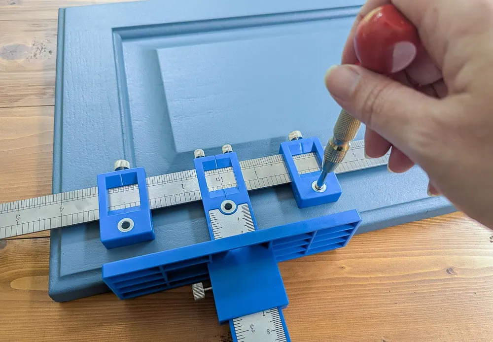using a hardware jig to mark hardware holes.