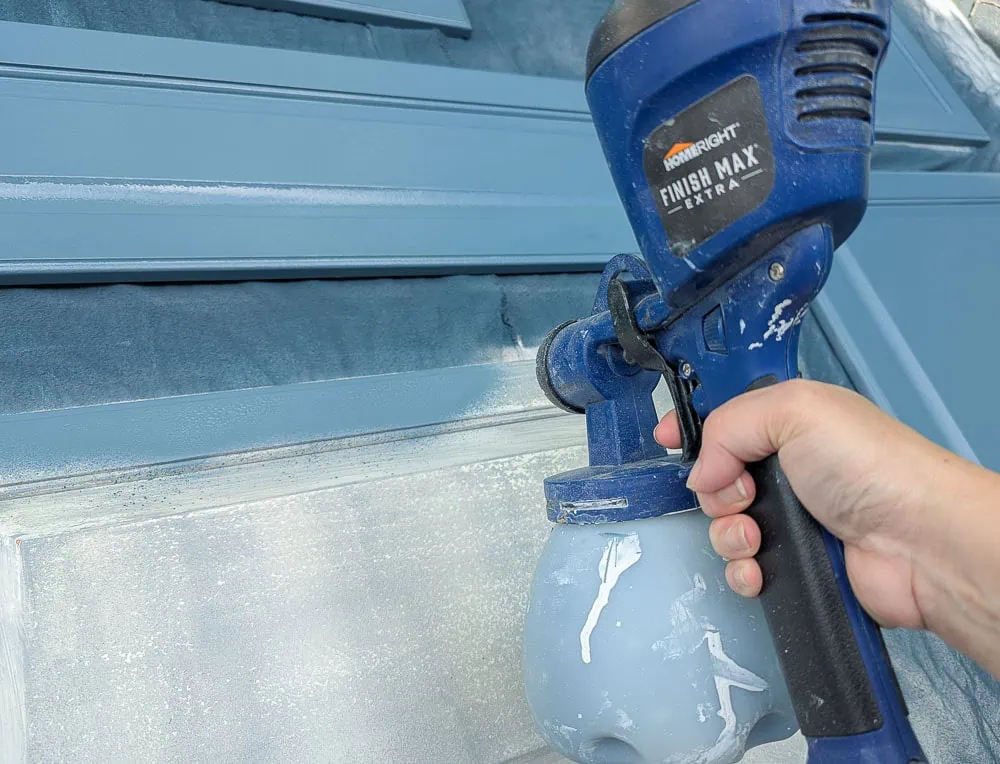 painting cabinet doors with a paint sprayer.