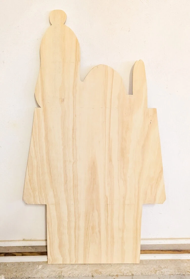 plywood cutout of Snoopy on his doghouse before paint.