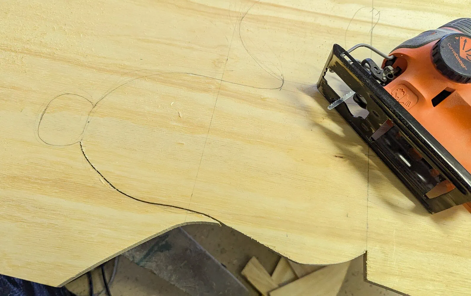 cutting the outline of Snoopy out of plywood using a Jigsaw.