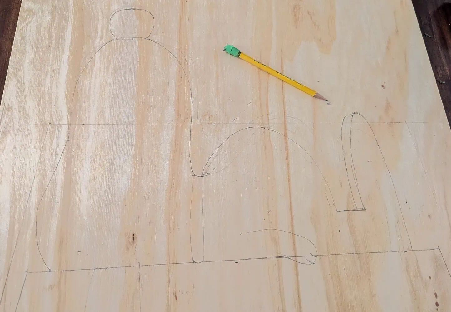 outline of Snoopy drawn on plywood.