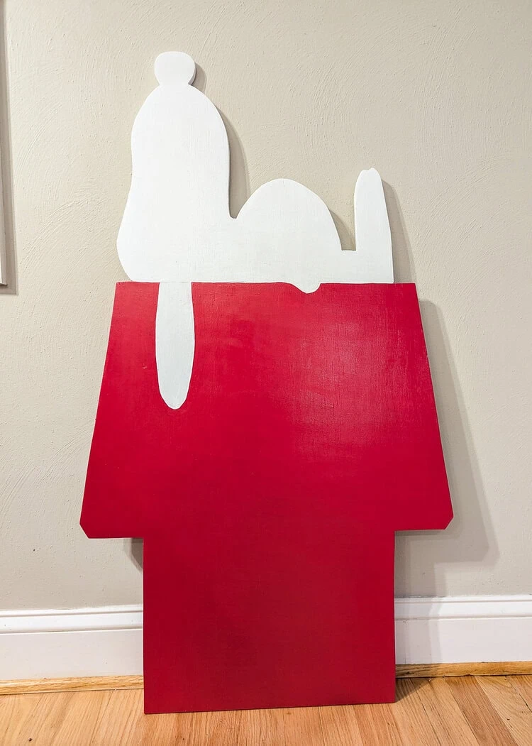 Snoopy on his doghouse after painting red and white.